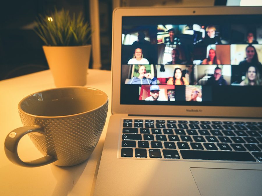 A laptop showing a live video call with members